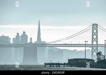 Idyllic view of suspension Bay Bridge and urban skyline with sky in background Stock Photo