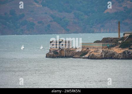 Distant view of old buildings on Alcatraz Island amidst San Francisco Bay Stock Photo