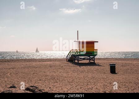 Colorful lifeguard hut on sand at Venice beach with view of sea and sky Stock Photo