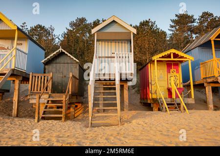 Colourful beach huts on stilts at Wells-Next-the-Sea on the North Norfolk coast Stock Photo