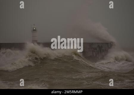 Newhaven, East Sussex, UK. 30th Dec, 2022. Blustery South Westerly wind whips up the waves at the end of another day on the Sussex coast. Further wild wet & windy weather is forecast but it remains relatively warm for the time of year. Credit: David Burr/Alamy Live News Stock Photo