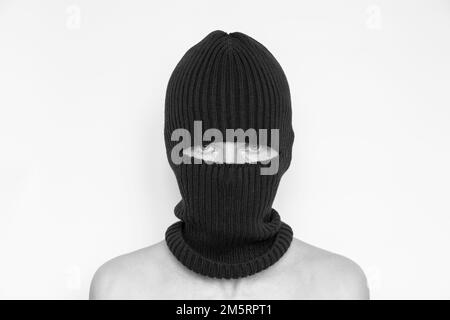 Hat balaclava on a girl on a white background, the face of a thief in hats with a slit for verbs Stock Photo