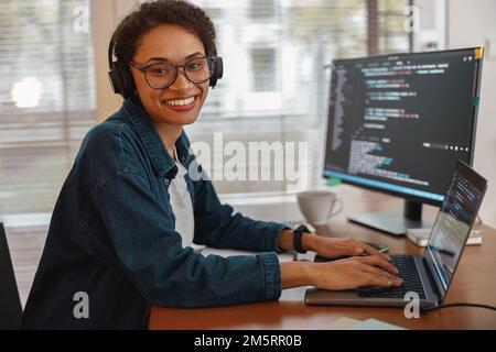 Afro american woman in headphones freelance data scientist work remotely at home office Stock Photo