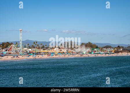 Distant view of amusement park rides and Santa Cruz Beach in front of ocean Stock Photo