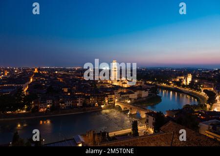 Verona, Italy - June 2022: panorama by night. Illuminated cityscape with scenic bridge Stock Photo