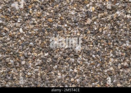 Road and plaster grit, loose chippings, crushed stone, surface, from above. Dry lime- and iron-free quartz sand, used as spreading grit or aggregate. Stock Photo