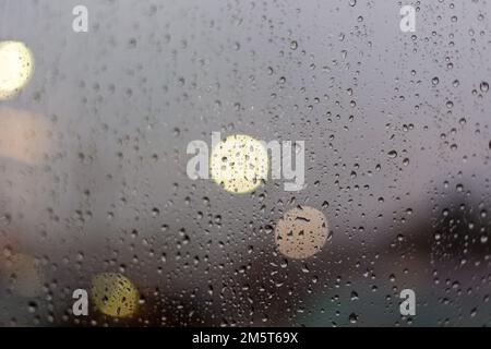 Close Up of Water Droplets on Window After Storm, Street Lights, Globes Stock Photo