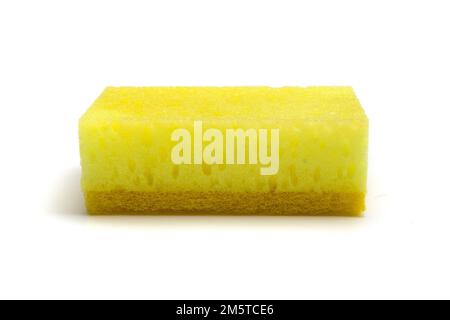 Single yellow kitchen sponge isolated on white background, closeup side view Stock Photo