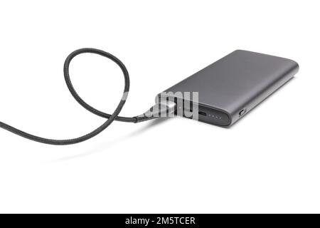 Fully charged portable powerbank with cable and two usb outputs isolated on a white background. Powerbank for charging mobile devices. Stock Photo