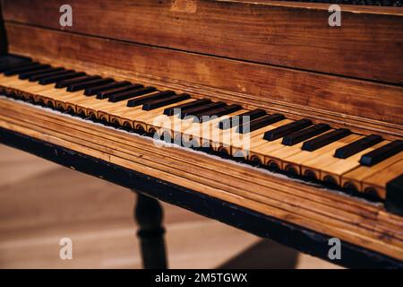 Old wooden piano keys on wooden musical instrument in front view. High quality photo Stock Photo