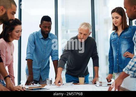 Working on a new project. a group of architects in the boardroom. Stock Photo