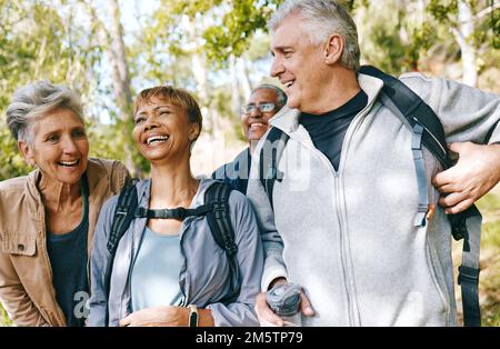 Hiking, elderly and people, happy outdoor with nature, fitness and fun in park, exercise group trekking in Boston. Diversity, friends and happiness Stock Photo