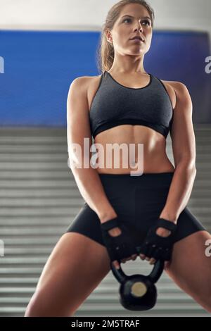 It takes dedication to reach your fitness goals. Cropped portrait of a young  female athlete against white background Stock Photo - Alamy