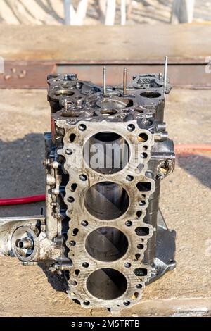 Closeup of a four cylinder engine block for repair in workshop Stock Photo