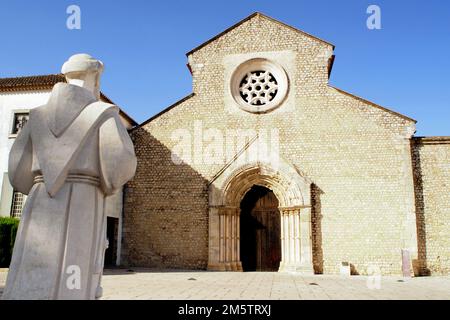 Statue of St. Francis facing Gothic portal of the Convent of Sao Francisco founded in 1242, Santarem, Portugal Stock Photo