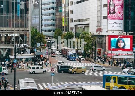 Public Vehicles driving through the Shibuya intersection Stock Photo