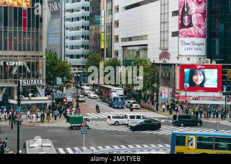 Public Vehicles driving through the Shibuya intersection Stock Photo