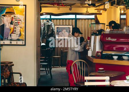 A young customer making payment at a cafe Stock Photo