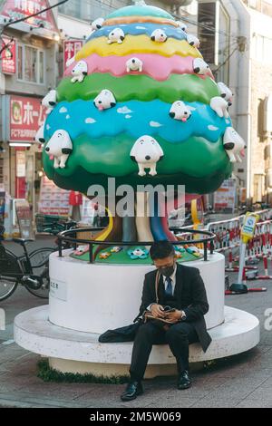 A man sitting alone focusing on his phone Stock Photo
