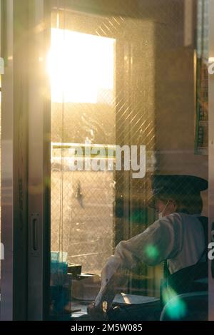 A security guard on duty in a booth Stock Photo