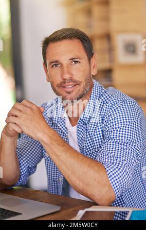 Its great to be working from home. a young man working from home. Stock Photo