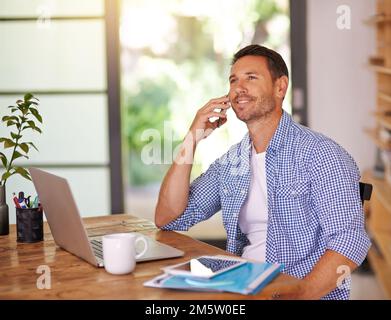 Connected to his clients. a young man working from home. Stock Photo