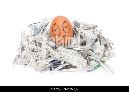 egg face sleepy on newspapers recycle. Stock Photo