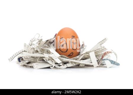 egg face sleepy on newspapers recycle. Stock Photo