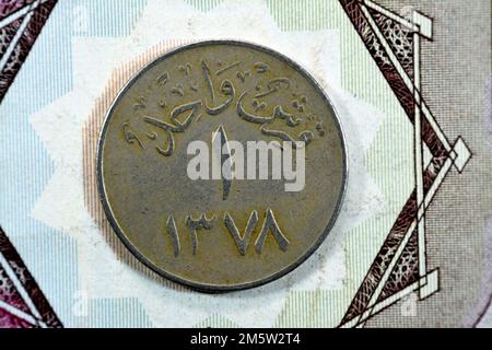 Translation of Arabic (One Piaster 1378) from the reverse side of an old Saudi Arabia one piastre 5 five Halalah coin, vintage retro old Saudi money c Stock Photo