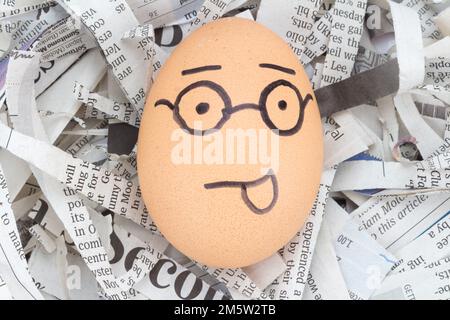 egg face glasses on newspapers recycle. Stock Photo