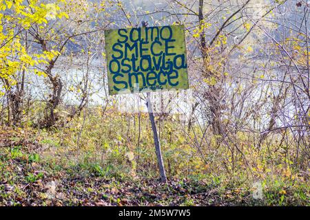 Wooden warning sign, at the entrance to the forest. Stock Photo