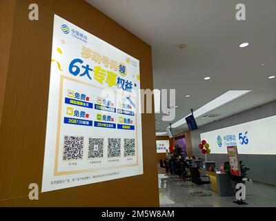 SUQIAN, CHINA - DECEMBER 31, 2022 - Citizens handle 5G services at the business hall of China Mobile in Suqian, Jiangsu province, China, Dec 31, 2022. Stock Photo