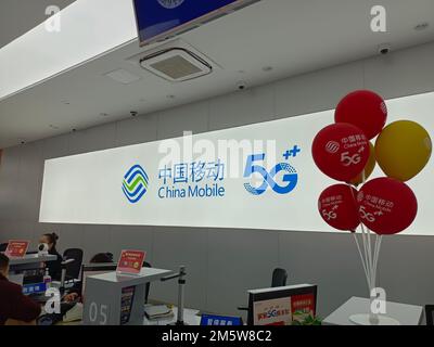 SUQIAN, CHINA - DECEMBER 31, 2022 - Citizens handle 5G services at the business hall of China Mobile in Suqian, Jiangsu province, China, Dec 31, 2022. Stock Photo