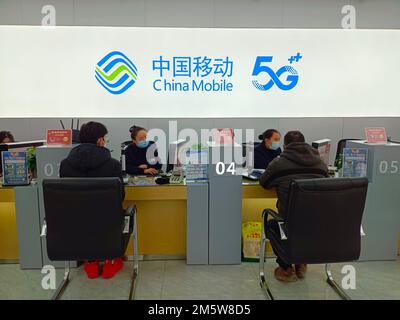 SUQIAN, CHINA - DECEMBER 31, 2022 - Citizens handle 5G services at the business hall of China Mobile in Suqian, Jiangsu province, China, Dec 31, 2022. Stock Photo