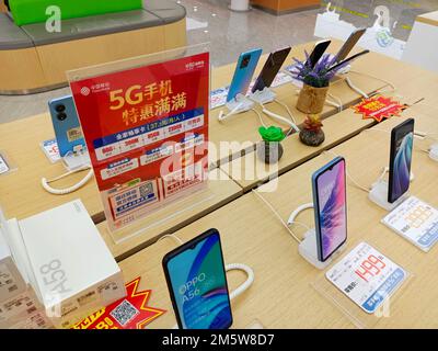 SUQIAN, CHINA - DECEMBER 31, 2022 - Citizens handle 5G services at the business hall of China Mobile in Suqian, Jiangsu province, China, Dec 31, 2022. Stock Photo