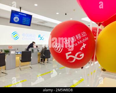 SUQIAN, CHINA - DECEMBER 31, 2022 - Citizens handle 5G services at the business hall of China Mobile in Suqian, Jiangsu province, China, Dec 31, 2022. Stock Photo