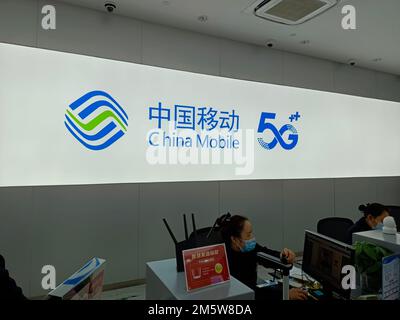 SUQIAN, CHINA - DECEMBER 31, 2022 - Citizens handle 5G services at the business hall of China Mobile in Suqian, Jiangsu province, China, Dec 31, 2022. Stock Photo