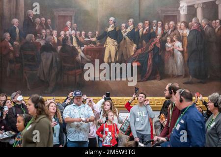 Washington DC, USA. 30th Dec, 2022. Washington, United States Of America. 30th Dec, 2022. Tourists stand under a painting “General George Washington Resigning His Commission” in the US Capitol Rotunda. 19 people in this painting have been identified as having been enslavers. Paintings of important moments in US history and sculptures of historic figures are on display, paying tribune to enslavers and Confederates at the US Capitol in Washington, DC, Friday, December 30, 2022. Credit: Rod Lamkey/CNP/Sipa USA Credit: Sipa USA/Alamy Live News Credit: Sipa USA/Alamy Live News Stock Photo