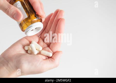 Probiotics. Preparation for restoration of intestinal microflora. Handful of white capsules with probiotic powder inside. The concept of health care Stock Photo