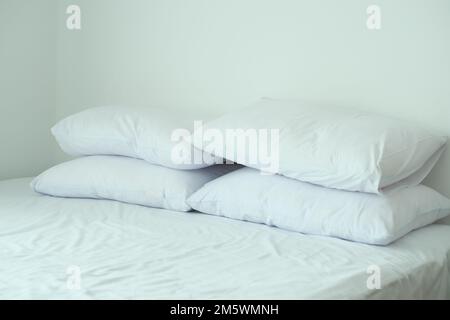white pillow lined up on bed  Stock Photo