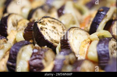 Sliced eggplant baked in the oven on a baking sheet. Delicious calorie vegetable. Vegetarian cuisine. Healthy diet food. Close up photography Stock Photo