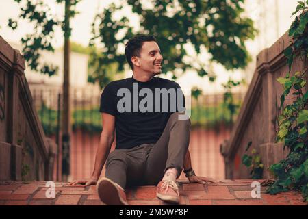 A handsome Hispanic young man posing in the park. Stock Photo