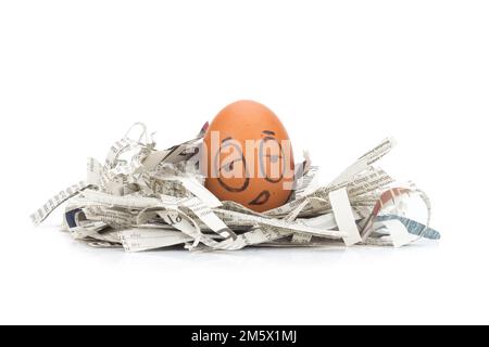 egg face sleepy on newspapers recycle. Stock Photo