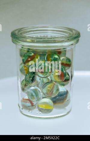 Collection Of Marbles Filled In A Glass Jar Stock Photo