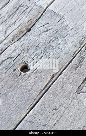 Wooden picnic table planks covered with a fine covering of frost crystals. For UK cold weather snap, frost abstract, or abstract cold weather. Stock Photo