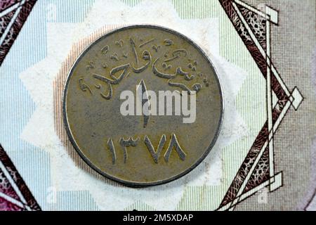 Translation of Arabic (One Piaster 1378) from the reverse side of an old Saudi Arabia one piastre 5 five Halalah coin, vintage retro old Saudi money c Stock Photo