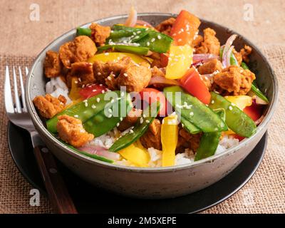 Vegetable Stir-fry with TVP pieces on rice Stock Photo