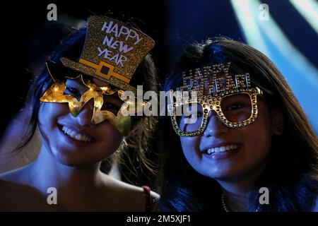 Manila, Philippines. 1st Jan, 2023. Women wear themed glasses during a New Year's Eve party at a beach resort in Subic Bay Freeport, northwest of Manila, Philippines. January 1, 2023. (Credit Image: © Basilio Sepe/ZUMA Press Wire) Credit: ZUMA Press, Inc./Alamy Live News Stock Photo