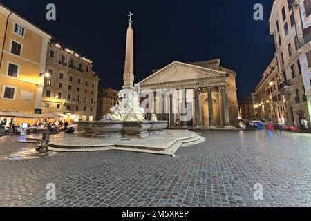 The Pantheon in Rome as well as the surrounding square at night time Stock Photo