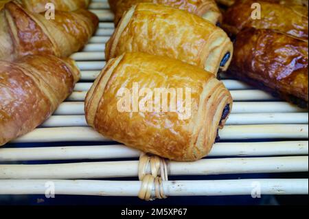 French bakery, fresh baked sweet buns and rolls on display in small French bakery in Paris, France Stock Photo
